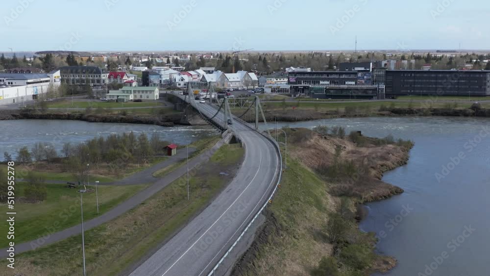 Flying towards small town Selfoss in Iceland with Ölfusárbrú bridge crossing Olfusa river, aerial Flying towards small town Selfoss in Iceland with Ölfusárbrú bridge crossing Olfusa river, aerial