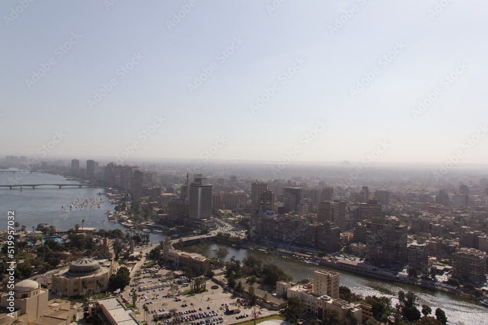 Ariel view of Cairo Egypt, a sprawling concrete megacity with Pyramids in the distance