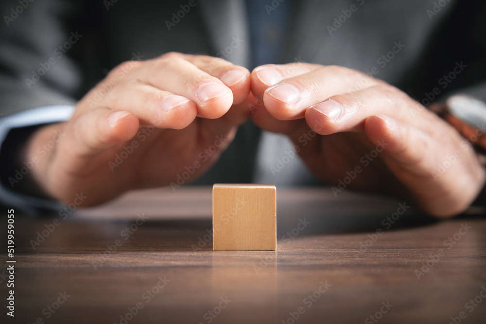 Businessman protect wooden empty cube. Businessman protect wooden empty cube.