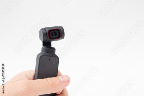 Man hand holding Action Camera video gimbal stabilizator on white background