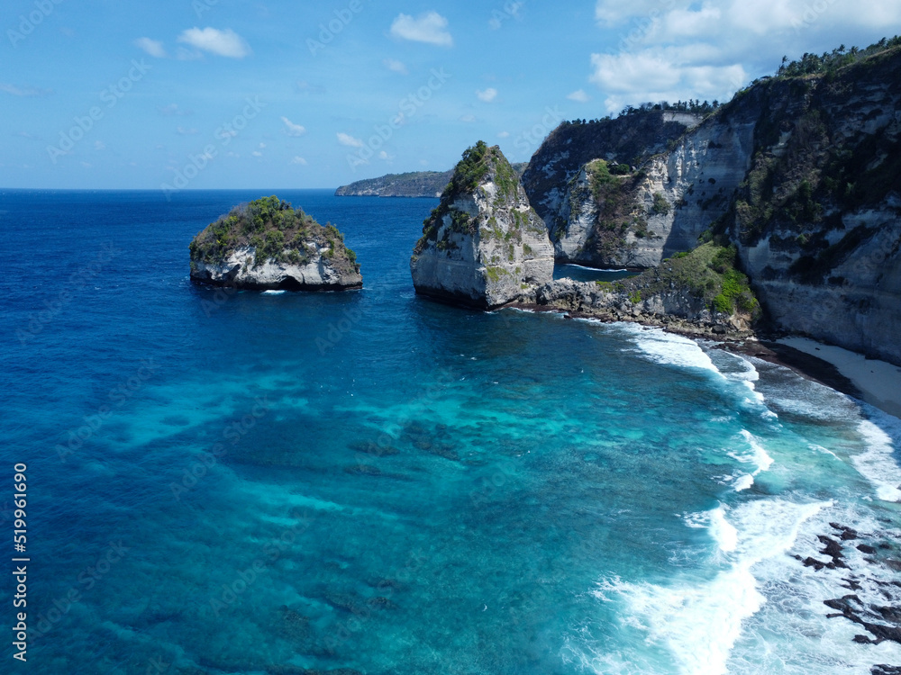 Aerial photo of Nusa Penida bay, white waves and crystal clear water in Bali
