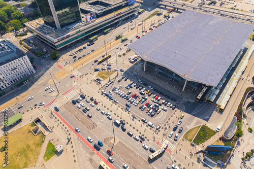 Transportation and train journey concept. Railway station, parking with cars, and busses. Aerial view from drone. High quality photo