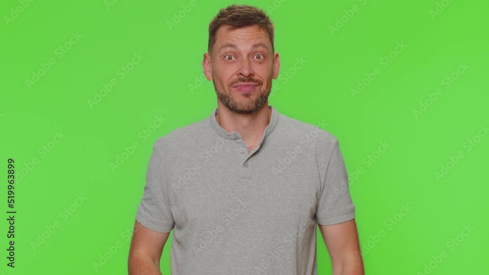 Bearded handsome funny man in t-shirt making playful silly facial expressions and grimacing, fooling around, showing tongue. Adult male guy isolated alone on chroma key studio background indoors Bearded handsome funny man in t-shirt making playful silly facial expressions and grimacing, fooling around, showing tongue. Adult male guy isolated alone on chroma key studio background indoors