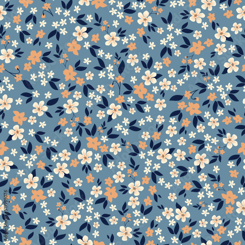 Simple vintage pattern. small white and orange flowers, dark blue leaves. blue background. Fashionable print for textiles and wallpaper. photo