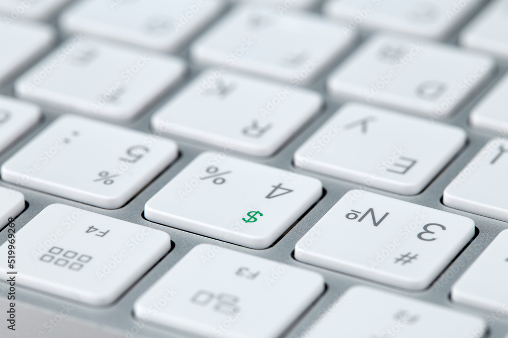 Dollar icon highlighted in green on the monochrome keyboard of a modern computer. Horizontal. Trading technologies and earnings on crypto exchanges. Dollar icon highlighted in green on the monochrome keyboard of a modern computer. Horizontal. Trading technologies and earnings on crypto exchanges.