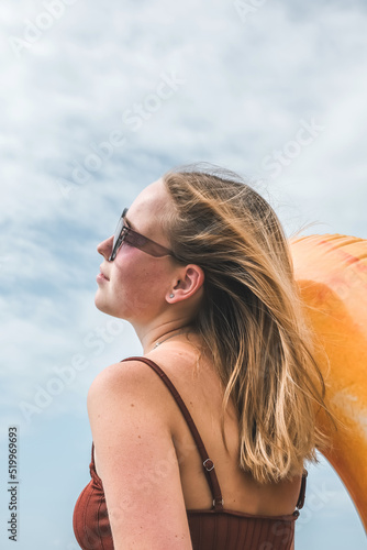 Traveler girl resting on the beach near the sea. Eco travel, taking care of yourself physical and mental health. Slow life and sea holidays. work and leisure travel. Traveling outdoor