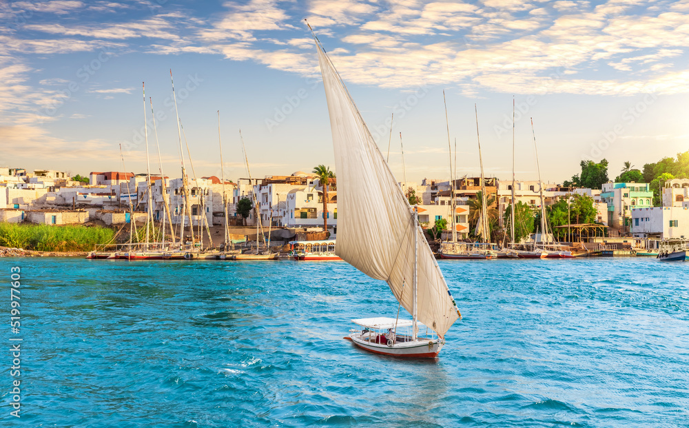 Traditional buildings of Aswan city and Sailboat on the Nile, Egypt