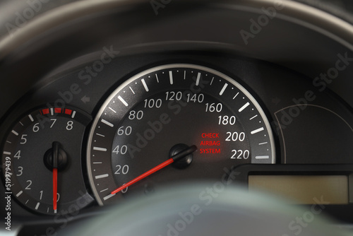 Closeup view of dashboard with warning icon check airbag system in car