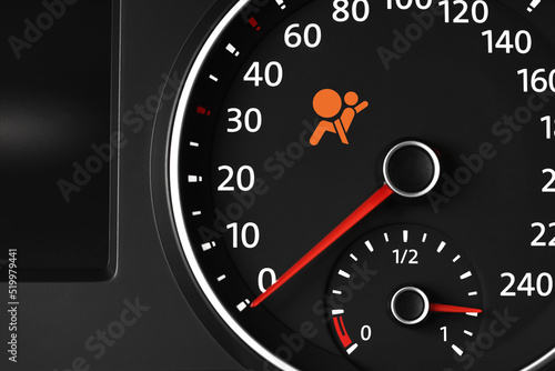Closeup view of dashboard with warning icon check airbag system in car
