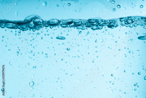 blue splash of water in a glass vessel. clean clear water
