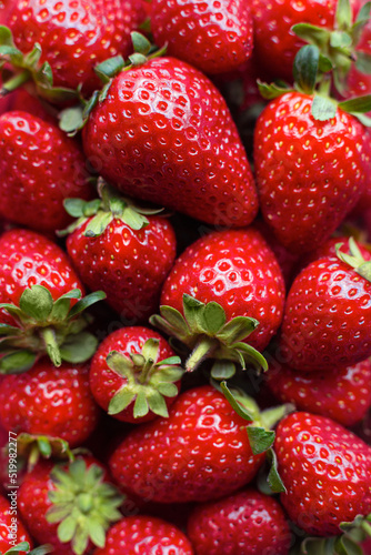 Lots of strawberries. A handful of sweet ripe strawberries. Combination of red and green.