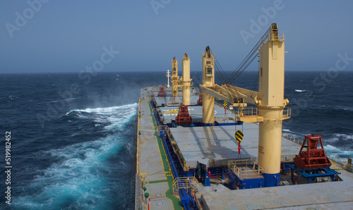 A merchant ship underway at sea in rough weather
