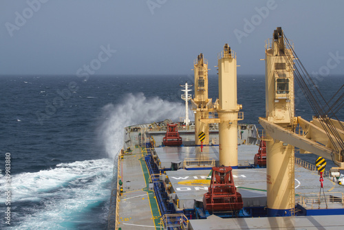 A merchant ship underway at sea in rough weather