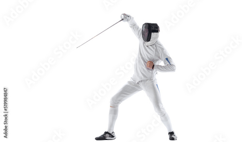 Dynamic portrait of young man, fencer in in fencing costume with sword in hand training isolated on white studio background. Sport, energy, skills photo