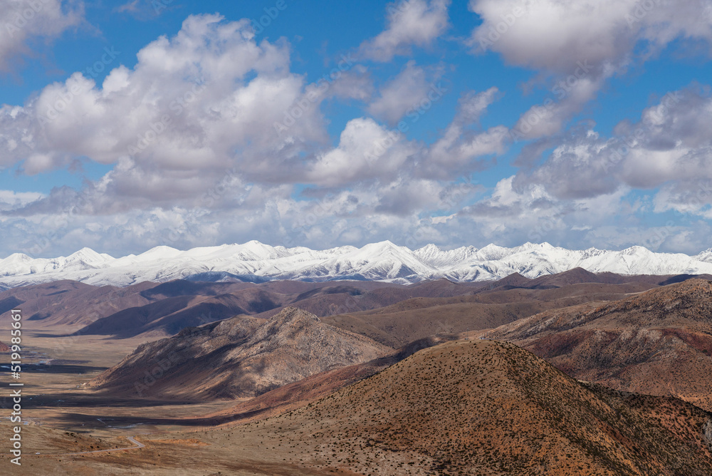 Barren mountain ranges with snow-capped mountain peaks