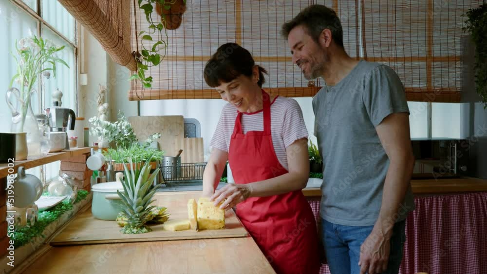 Middle aged couple making fruit salad Middle aged couple making fruit salad