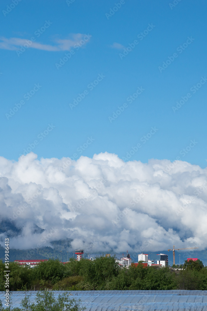 Thick clouds or mist moving round mountain forests and greenhouses