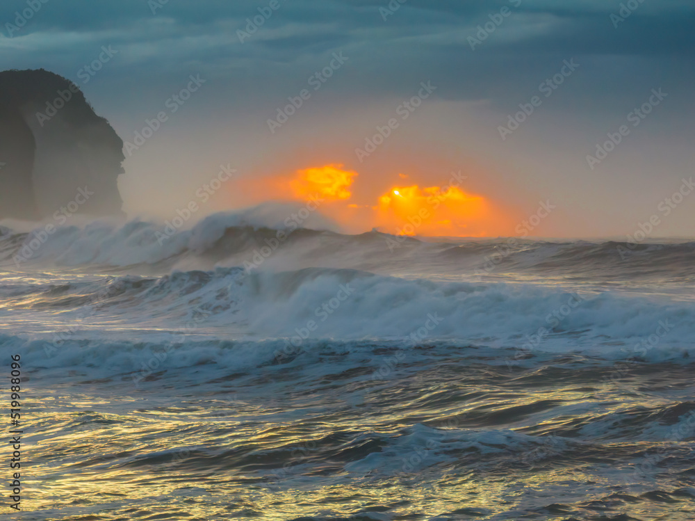Sunrise at the seaside with large and powerful sets