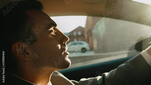 A successful businessman, banker, financier broker drives premium car work office, make deal client. Status, successful life rich person. Driving around metropolis. Personal driver leader premium taxi