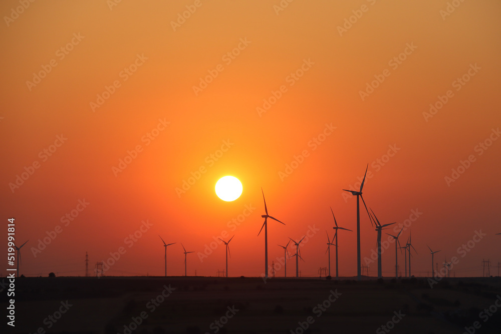 Obraz premium As the sun rose behind the hills, a brilliant golden light spread across the sky.