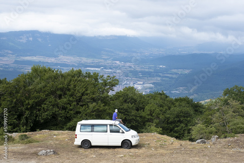man on a van looking out over the landscape