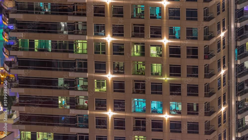 Windows in high-rise building exterior in the late evening with glowing and blinking interior lights on timelapse. Aerial top view Windows in high-rise building exterior in the late evening with glowing and blinking interior lights on timelapse. Aerial top view