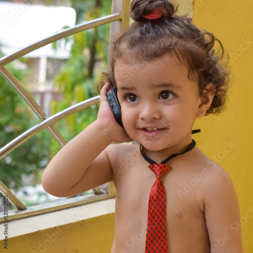 Cute little boy Shivaay at home balcony during summer time, Sweet little boy photoshoot during day light, Little boy enjoying at home during photo shoot photo