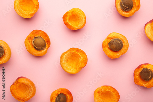 Fresh apricots on pink pastel background