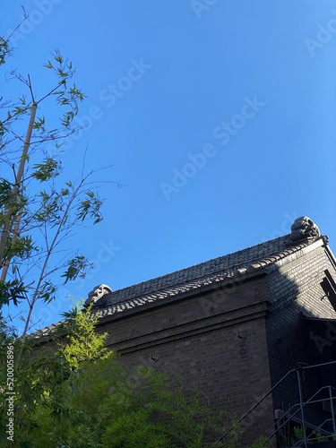 The old warehouse hut of traditional Japanese architecture, with silvery rooftop tiles, year 2022 July 28th, street of Nezu Tokyo Japan
 photo