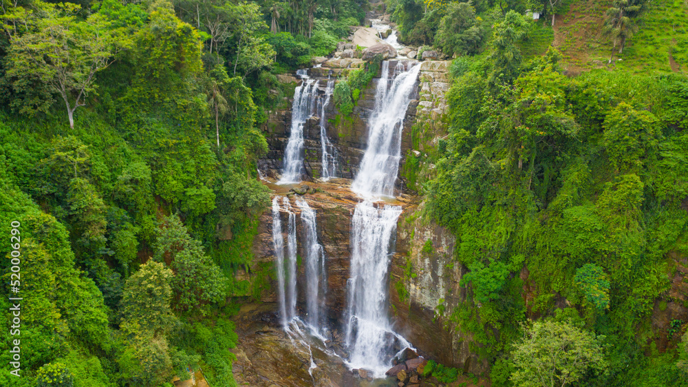 Waterfall in a tropical forest. Aerial view of Lower Ramboda Falls. Sri Lanka. Waterfall in a tropical forest. Aerial view of Lower Ramboda Falls. Sri Lanka.