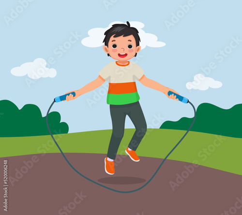 happy little boy skipping jumping rope at the park