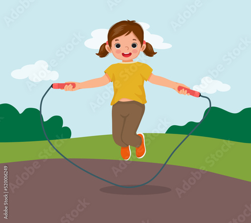 happy little girl skipping jumping rope at the park