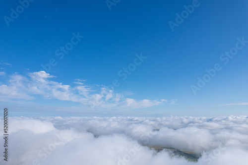 Flying over beautiful fluffy clouds © Pavel