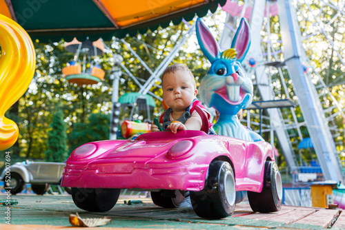 handsome little boy on amusement ride machine