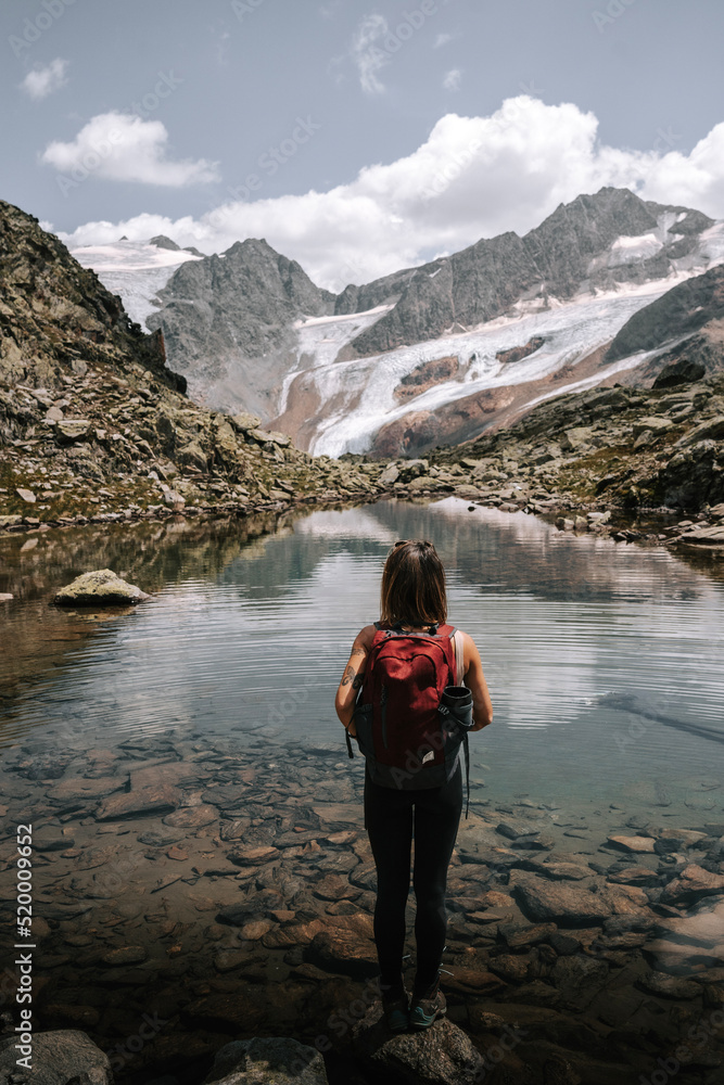 Eine Frau steht an einem Gletschersee vor dem Gletscher Weißkogel. Klimawandel am Gletscher. Sommer am Gletscher. Langtaufers Eine Frau steht an einem Gletschersee vor dem Gletscher Weißkogel. Klimawandel am Gletscher. Sommer am Gletscher. Langtaufers