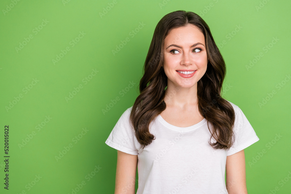 Photo of dreamy pretty young lady wear white t-shirt smiling looking empty space isolated green color background Photo of dreamy pretty young lady wear white t-shirt smiling looking empty space isolated green color background