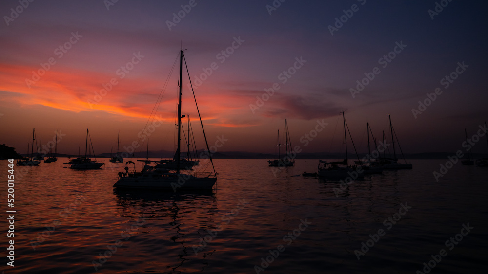 Sunset view of sailing boats at Notre Dame Beach in Porquerolles Island, var, france Sunset view of sailing boats at Notre Dame Beach in Porquerolles Island, var, france