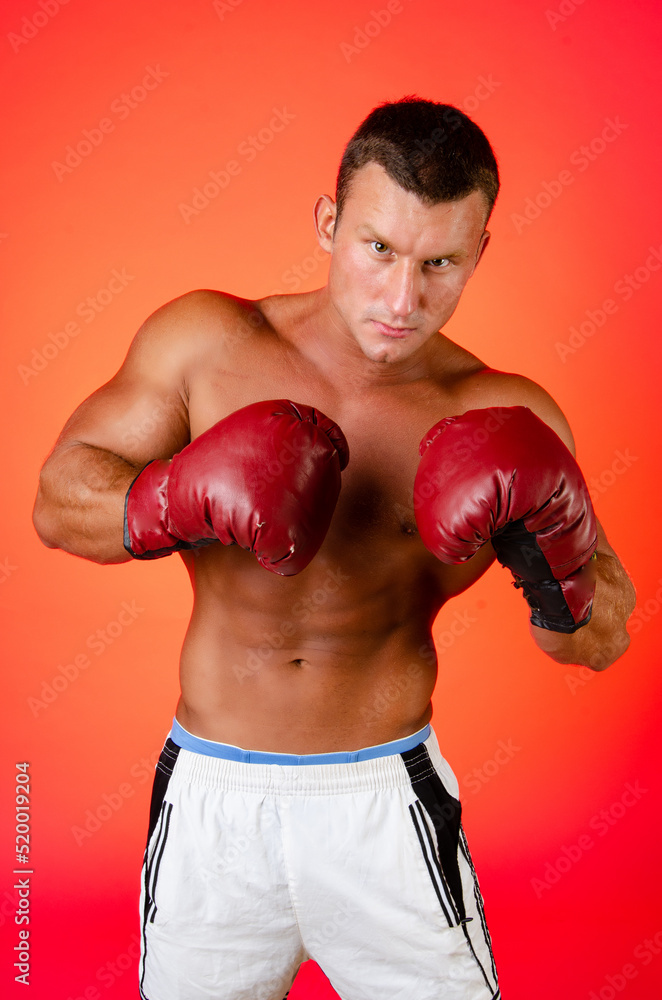 Young attractive boxer posing in the studio.	