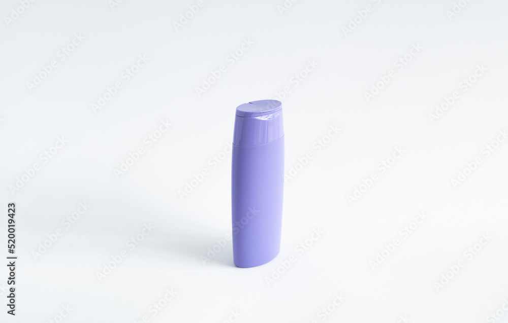 Violet plastic bottle of body care and beauty products. Studio photography of plastic bottle for shampoo, shower gel, creme isolated on white background. Violet plastic bottle of body care and beauty products. Studio photography of plastic bottle for shampoo, shower gel, creme isolated on white background.