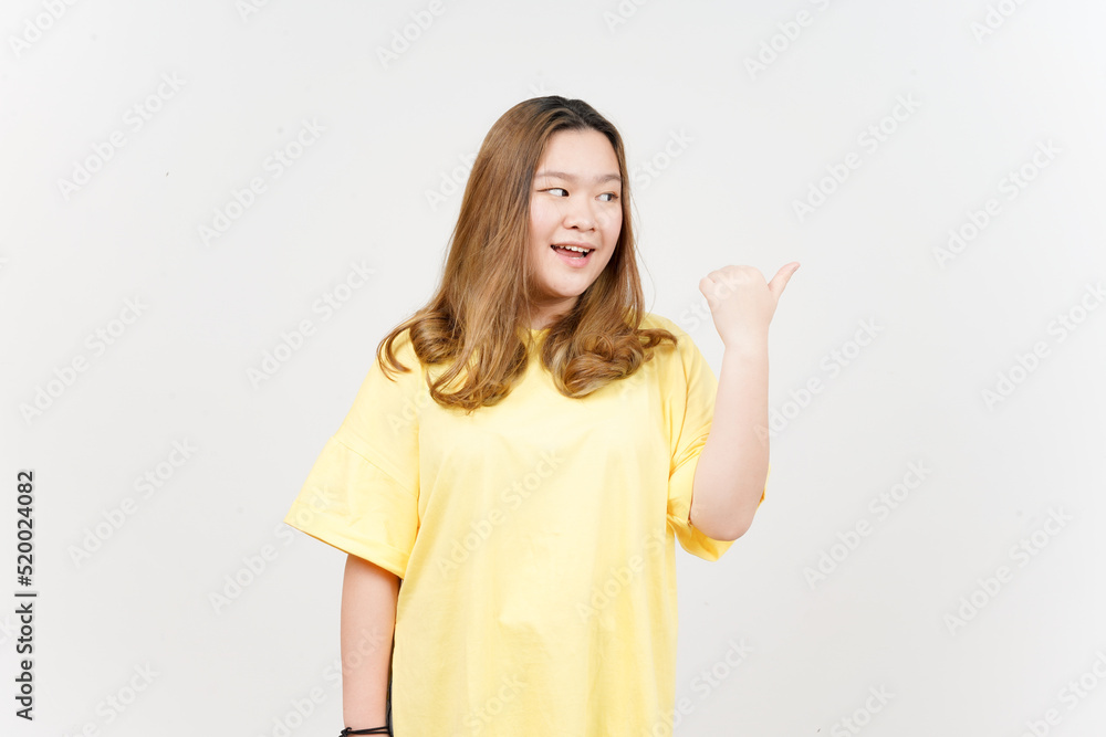 Presenting and Pointing Side Product Using Thumb of Beautiful Asian Woman wearing yellow T-Shirt Presenting and Pointing Side Product Using Thumb of Beautiful Asian Woman wearing yellow T-Shirt