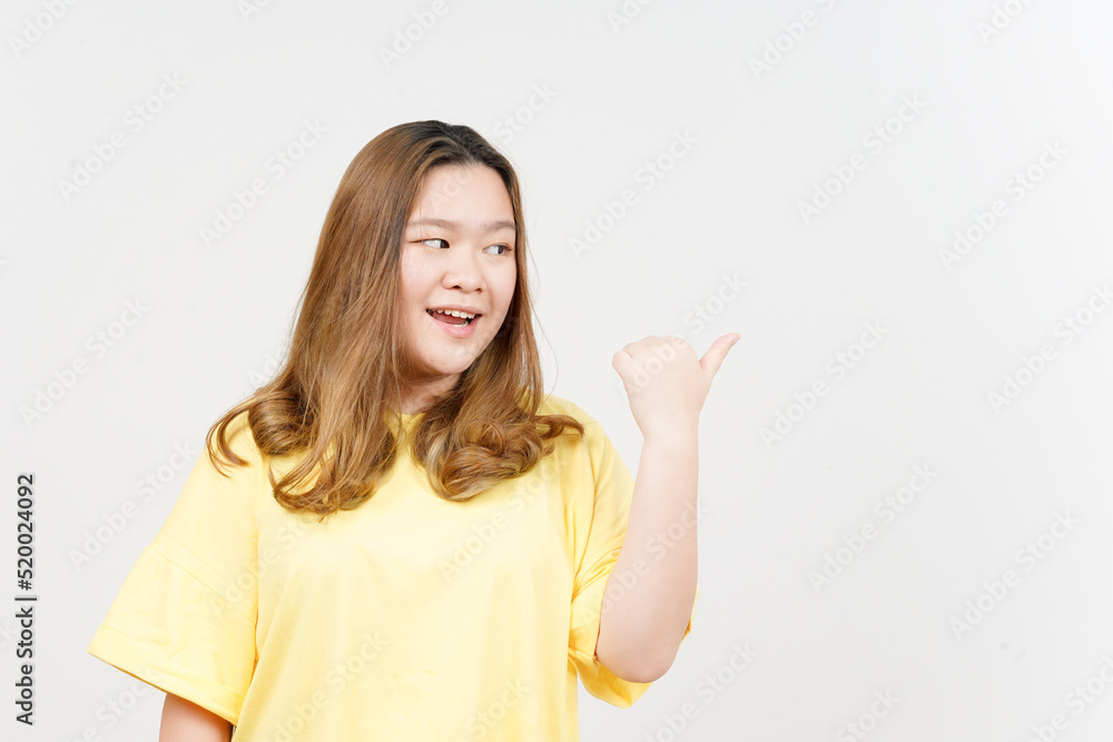 Presenting and Pointing Side Product Using Thumb of Beautiful Asian Woman wearing yellow T-Shirt Presenting and Pointing Side Product Using Thumb of Beautiful Asian Woman wearing yellow T-Shirt