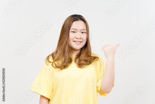 Wallpaper Mural Presenting and Pointing Side Product Using Thumb of Beautiful Asian Woman wearing yellow T-Shirt Torontodigital.ca