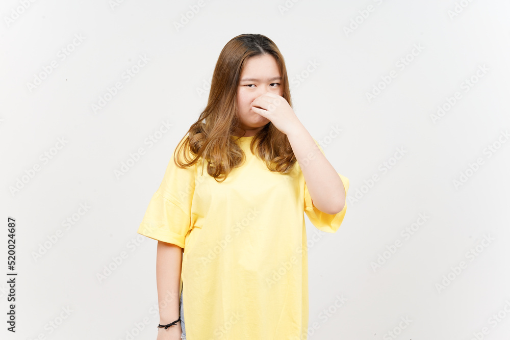 Fototapeta premium Smelling something stinky and disgusting of Beautiful Asian Woman wearing yellow T-Shirt