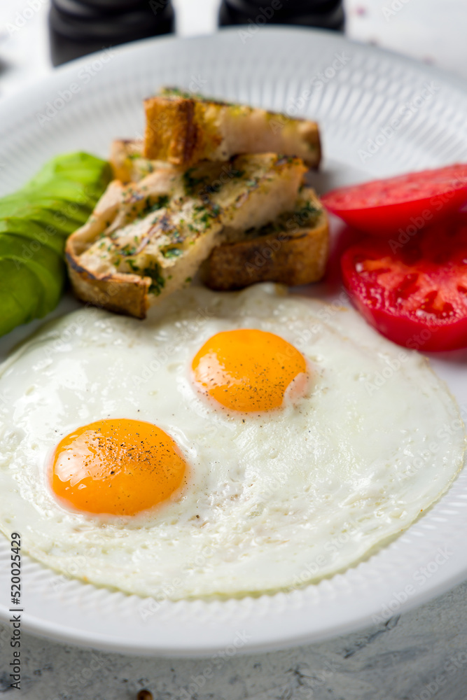 Fried eggs with tomatoes, avocado and fried croutons Fried eggs with tomatoes, avocado and fried croutons