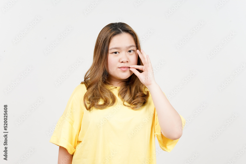 Keep Secret lip shut of Beautiful Asian Woman wearing yellow T-Shirt Isolated On White Background Keep Secret lip shut of Beautiful Asian Woman wearing yellow T-Shirt Isolated On White Background