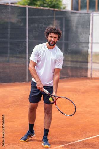 Portrait of tennis player man. front view. looking at camera. on the court © spoialabrothers