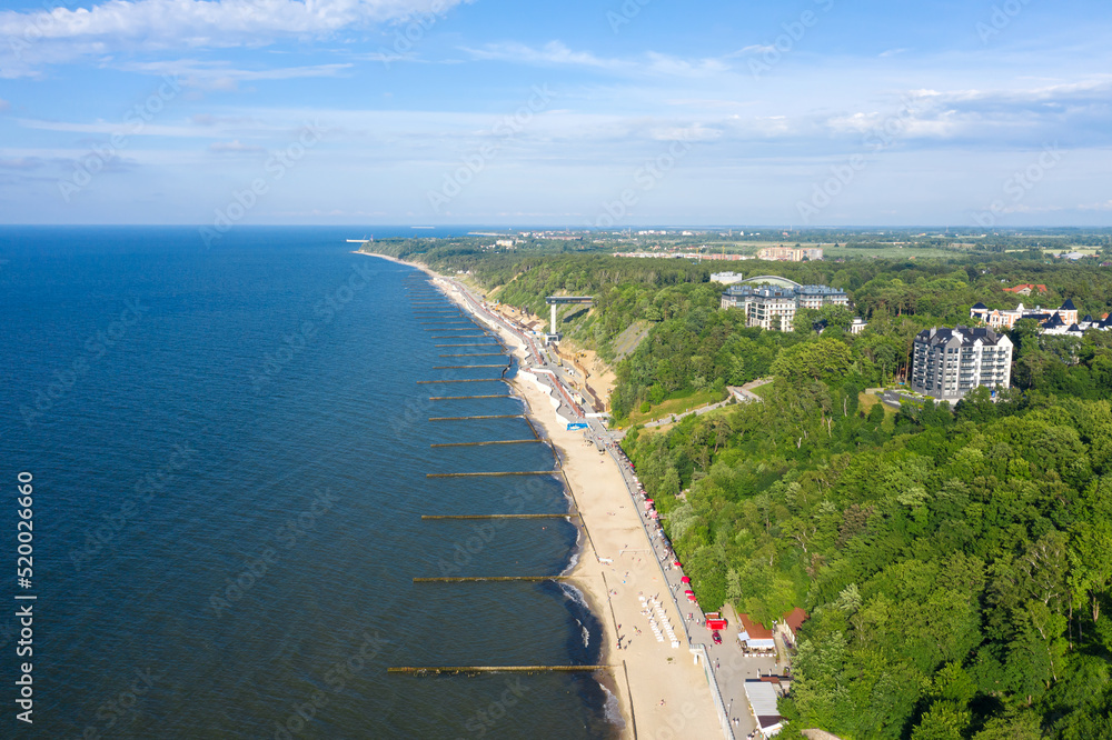 Obraz premium Summer Baltic Sea with embankment for promenade In Svetlogorsk. Kaliningrad region. Aerial view