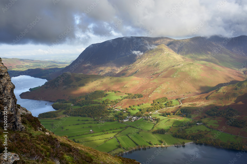 Views of the summits of Grasmoor, Whiteless Pike above Crummock Water and the village of Buttermere from High Stile in the Autumn in the Lake District, UK.