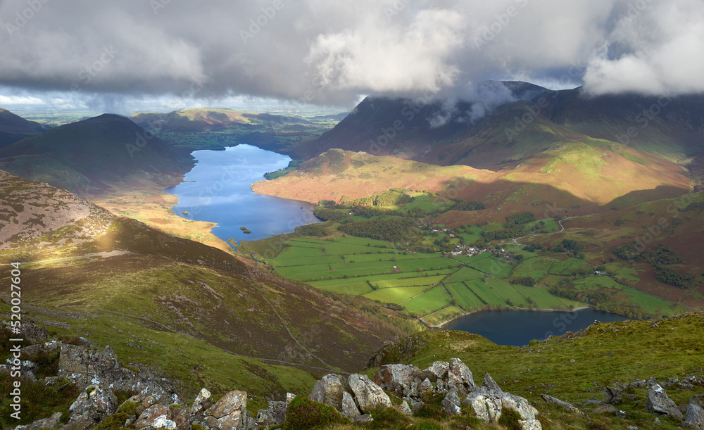 The cloud covered summit of Grasmoor above Crummock Water and Buttermere in Autumn in the Lake District, UK.
