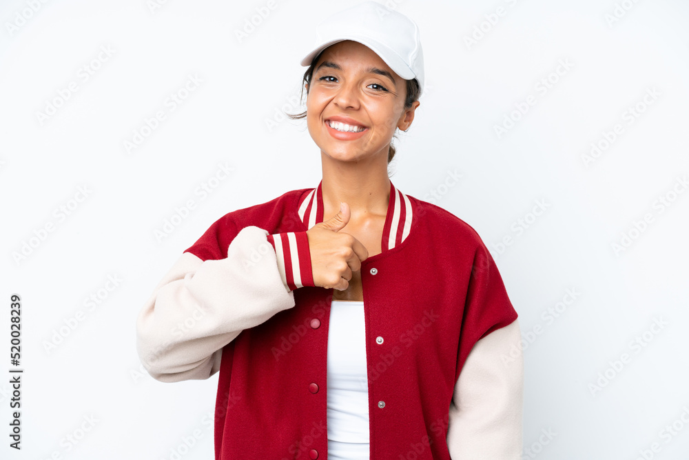 Young hispanic woman wearing a baseball uniform isolated on white background giving a thumbs up gesture Young hispanic woman wearing a baseball uniform isolated on white background giving a thumbs up gesture